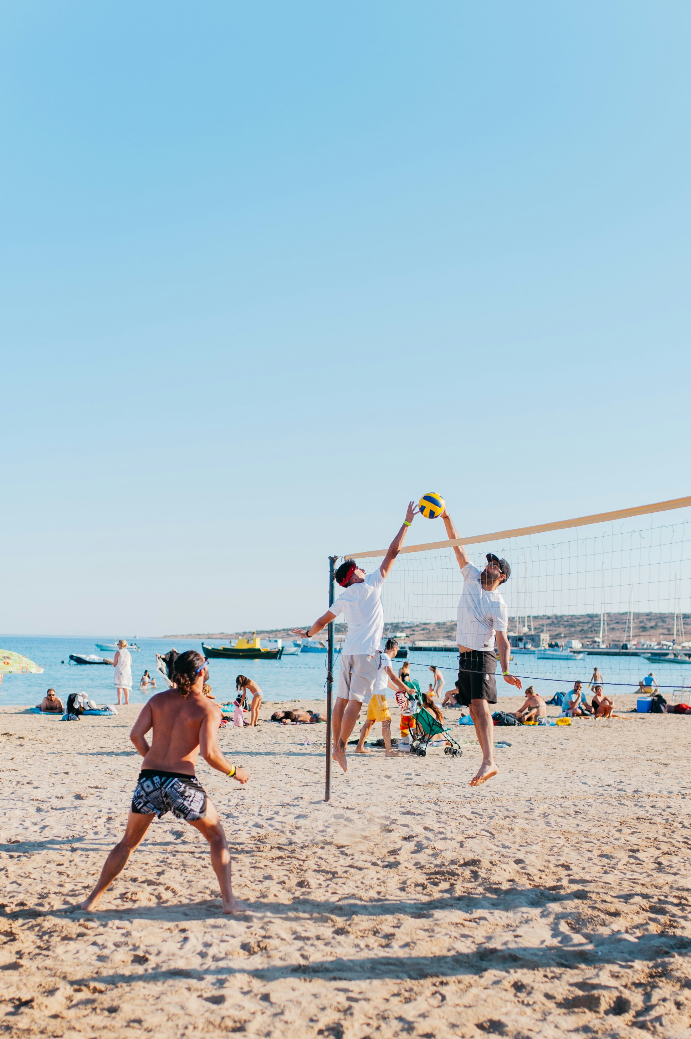 Eine Gruppe spielt Beachvolleyball am Strand