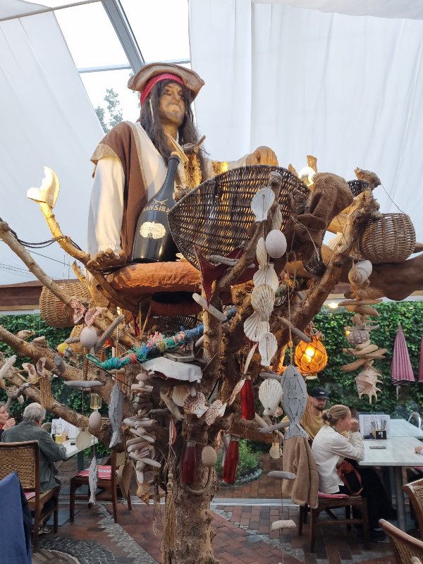 Piratensklulptur mit Fischernetz und Muscheln